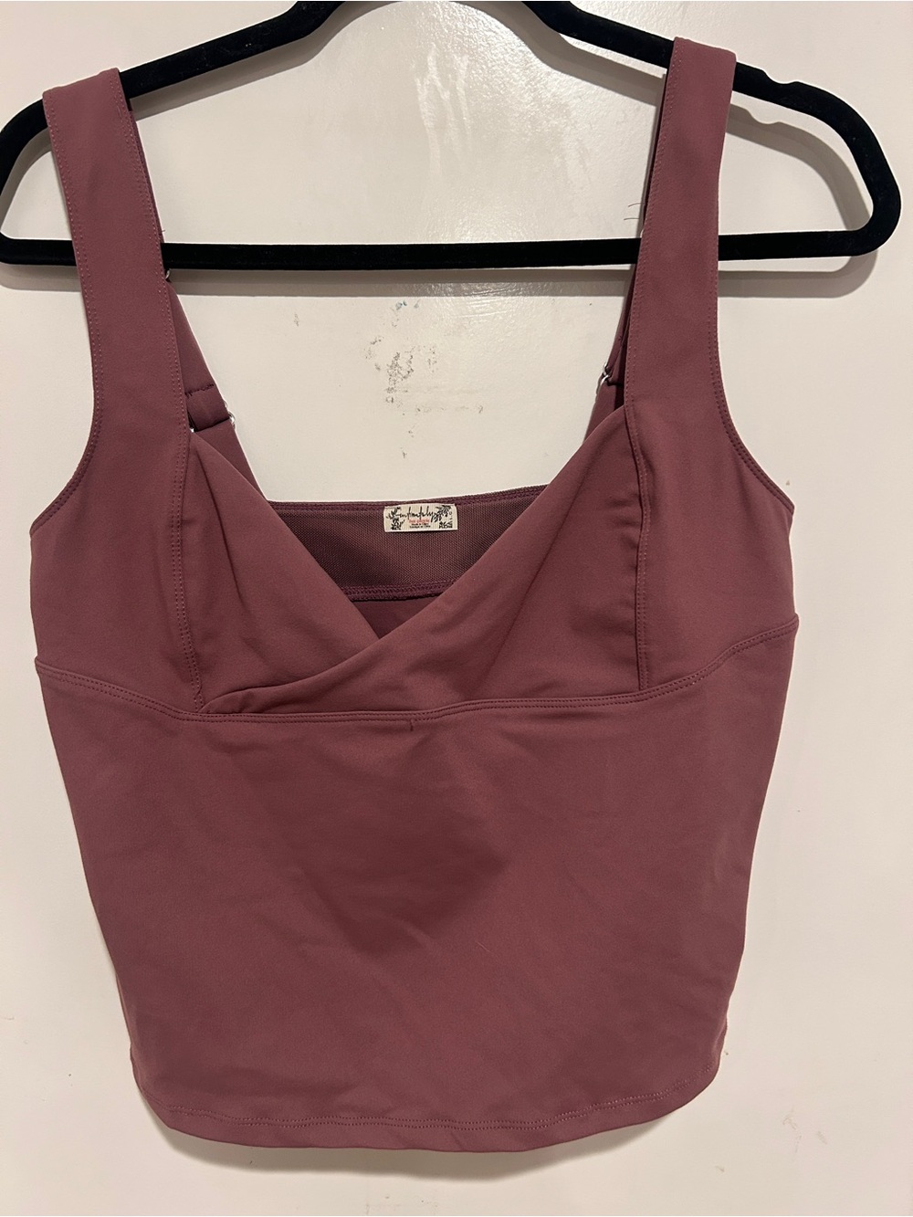 Free People wrap-front sports bra with a v-neckline and wide straps. Size large